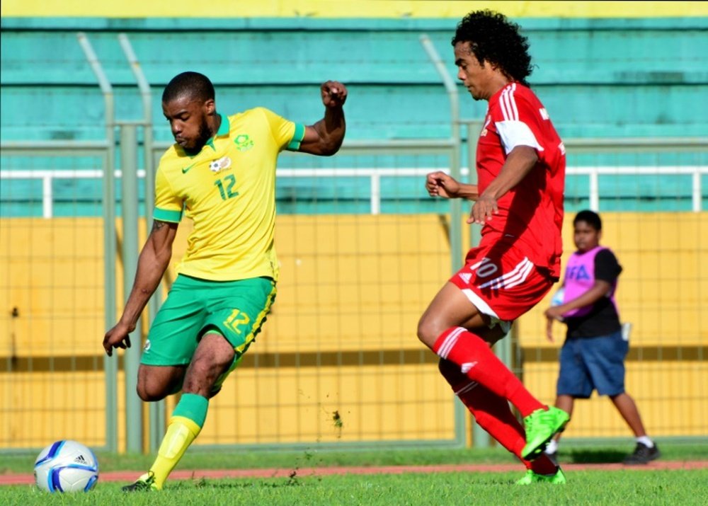 South African Bafana Bafana player Wamdisile Letlabika (L) fights Mauritius Club M player Perticots Kevin Joseph for possession during their 2016 African Nations Championship qualifier on July 5, 2015 in Mauritius
