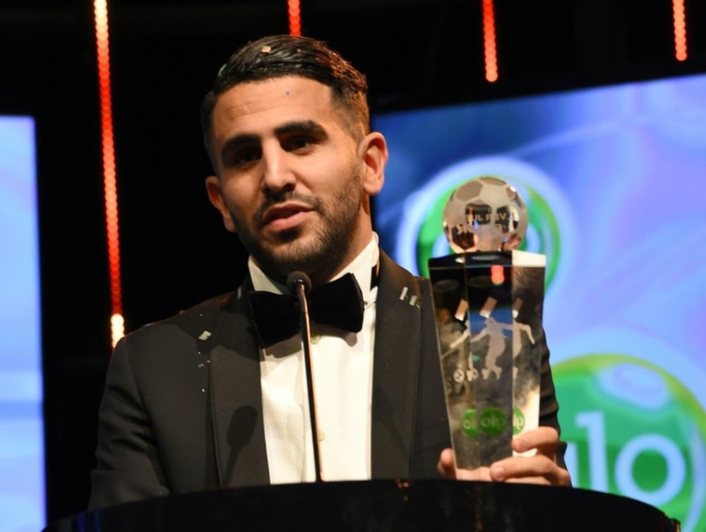 Algerian intl and Leicester midfielder Riyad Mahrez holds the trophy after being crowned African Footballer of the Year, in Abuja, on January 5, 2017