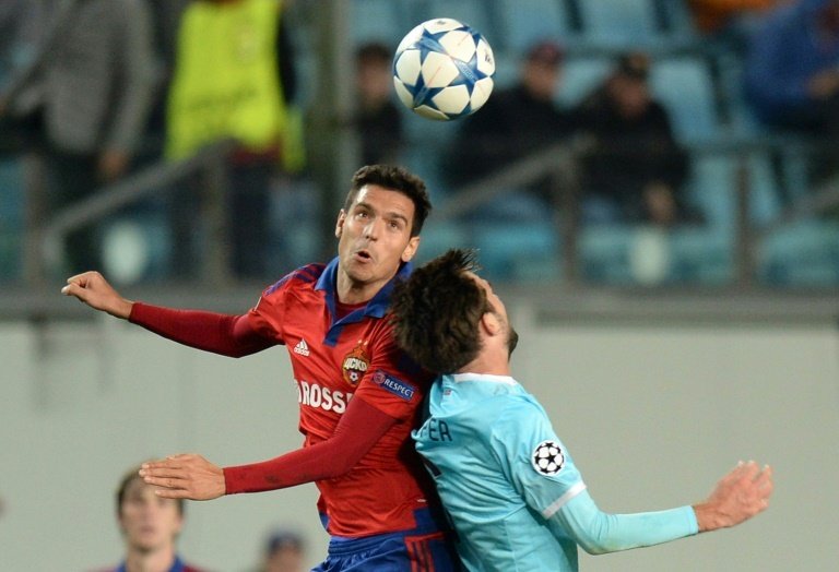 CSKA Moscows Bulgarian midfielder Georgi Milanov (L) fights for the ball with PSV Eindhovens Dutch midfielder Davy Propper during the UEFA Champions League group B football match at the Khimki Arena outside Moscow on September 30, 2015