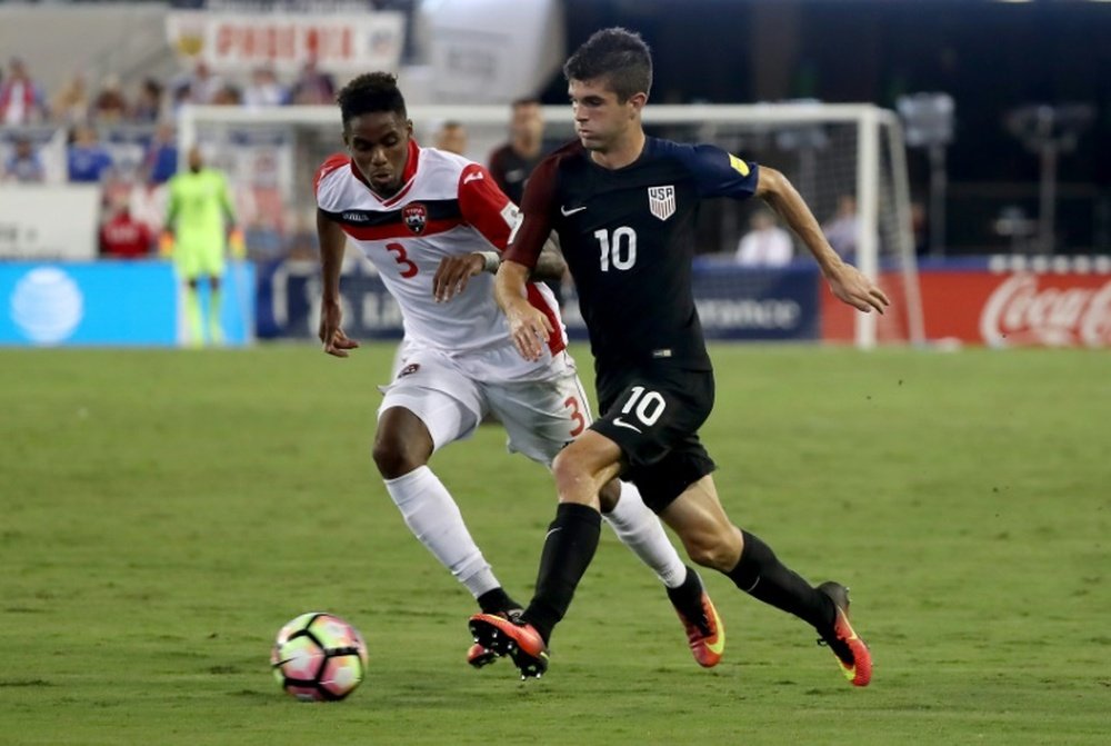 Christian Pulisic #10 of the United States drives past Joevin Jones #3 of Trinidad & Tobago during the FIFA 2018 World Cup Qualifier at EverBank Field on September 6, 2016