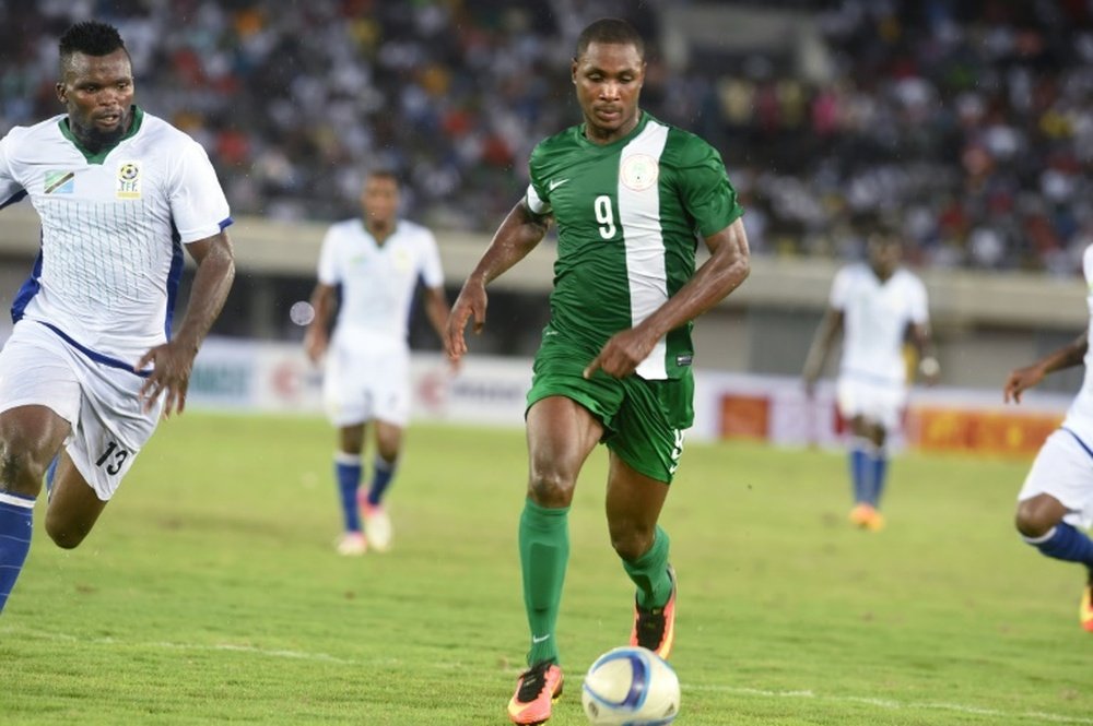 Nigeria and Watford striker Odion Ighalo (C) is tracked by Tanzania defender David Mwantika. AFP