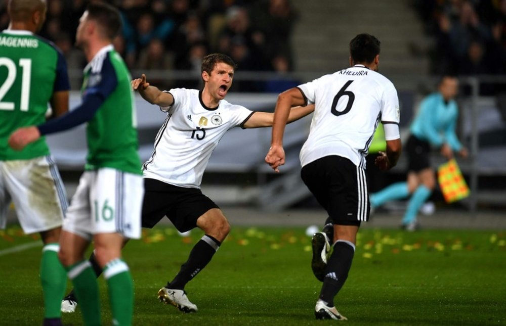 Germanys midfielder Sami Khedira (R) and his taemmates celebrate after scoring 2-0 during the WC 2018 football qualification match between Germany and Northern Ireland on October 11, 2016
