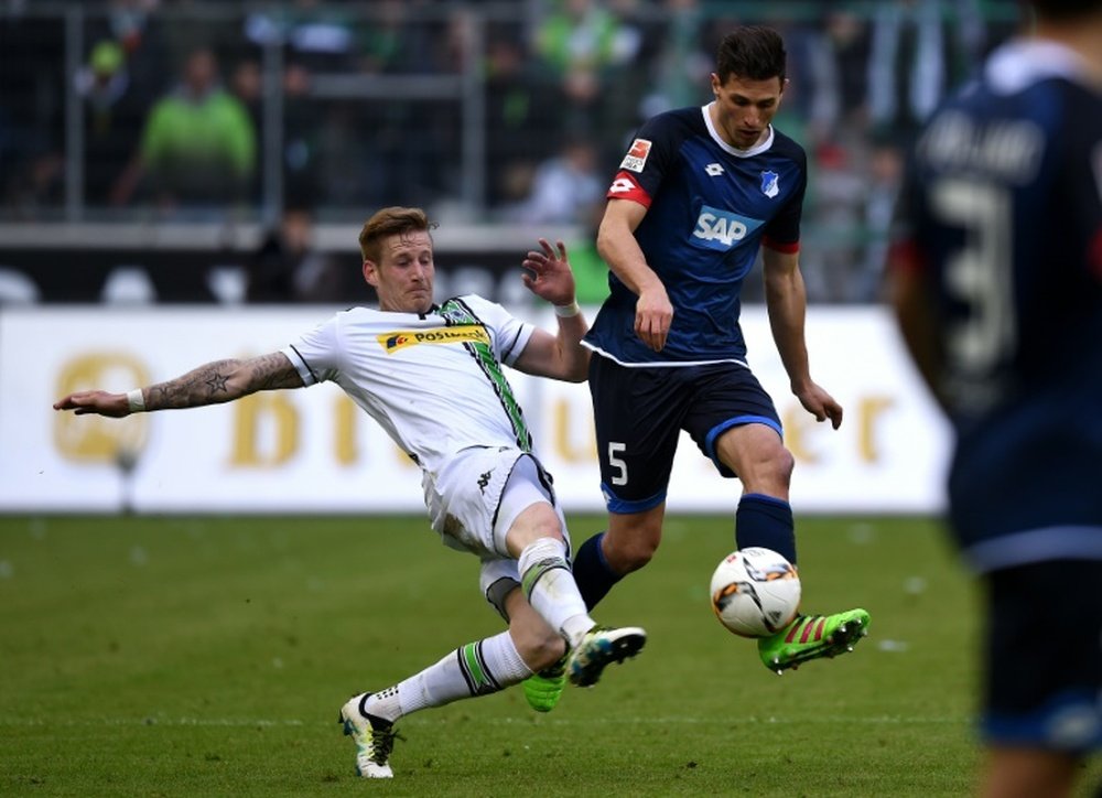 Moenchengladbachs midfielder Andre Hahn (L) and Hoffenheims Swiss defender Fabian Schaer vie for the ball during the German first division Bundesliga football match in western Germany, on April 24, 2016