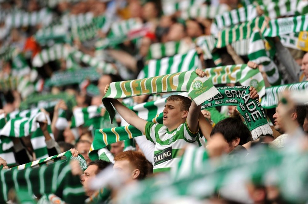 Celtic supporters sing before a match at Celtic Park in Glasgow, Scotland on May 24, 2009