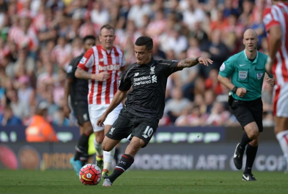 Liverpools midfielder Philippe Coutinho shoots to score against Stoke City at the Britannia Stadium in Stoke-on-Trent, central England on August 9, 2015