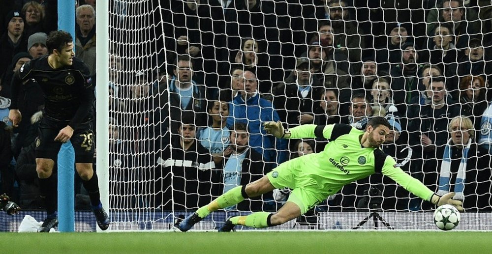 Celtics goalkeeper Craig Gordon dives to make a save during an UEFA. AFP