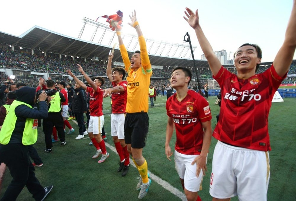 Guangzhou Evergrandes players celebrate after clinching the Chinese football championship, in Beijing, in October 2015
