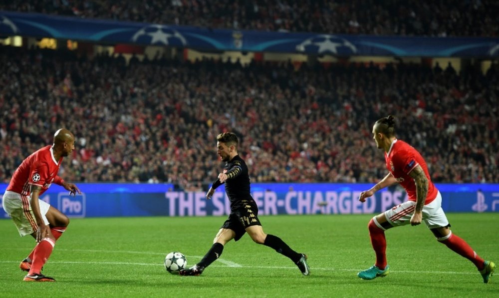 Napolis midfielder Dries Mertens (C) controls the ball past Benficas defender Luisao. AFP
