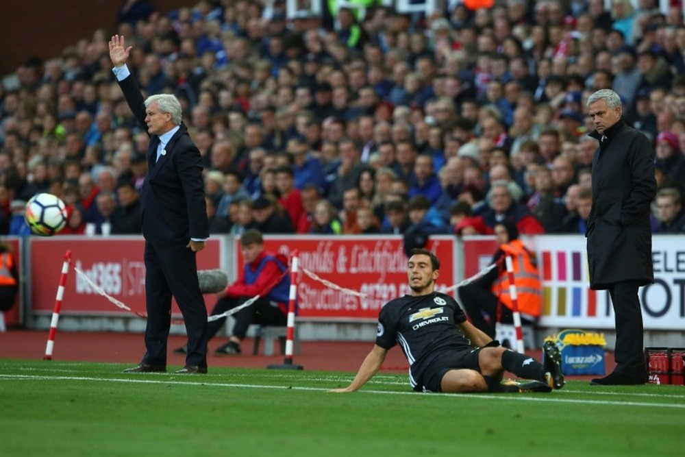 Mourinho and Hughes clashed on the touchline during the 2-2 draw between Man United and Stoke. AFP