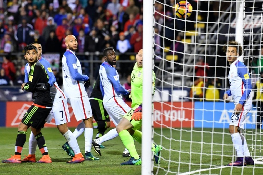 United States goalkeeper Brad Guzan (2R) watches helpless as a header from Rafael Marquez of Mexico (not pictured) gives them the winning goal in their World Cup qualifier