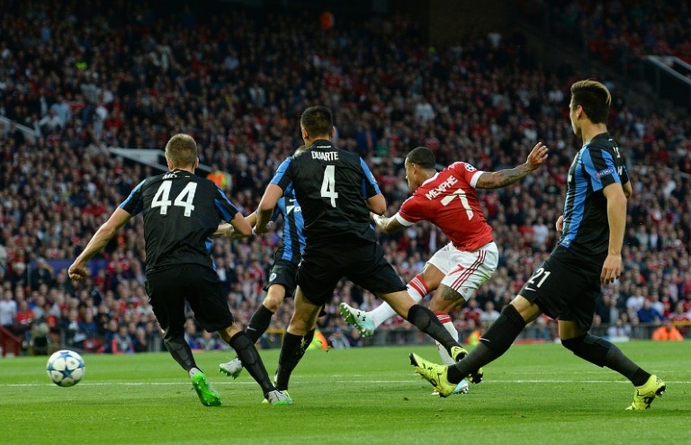 Manchester Uniteds Memphis Depay (2nd R) scores his teams first goal during the UEFA Champions League play off against Club Brugge at Old Trafford on August 18, 2015