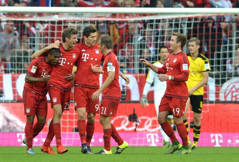 Bayern Munichs players celebrate scoring a goal during their German first division Bundesliga match against Borussia Dortmund, in Munich, on October 4, 2015