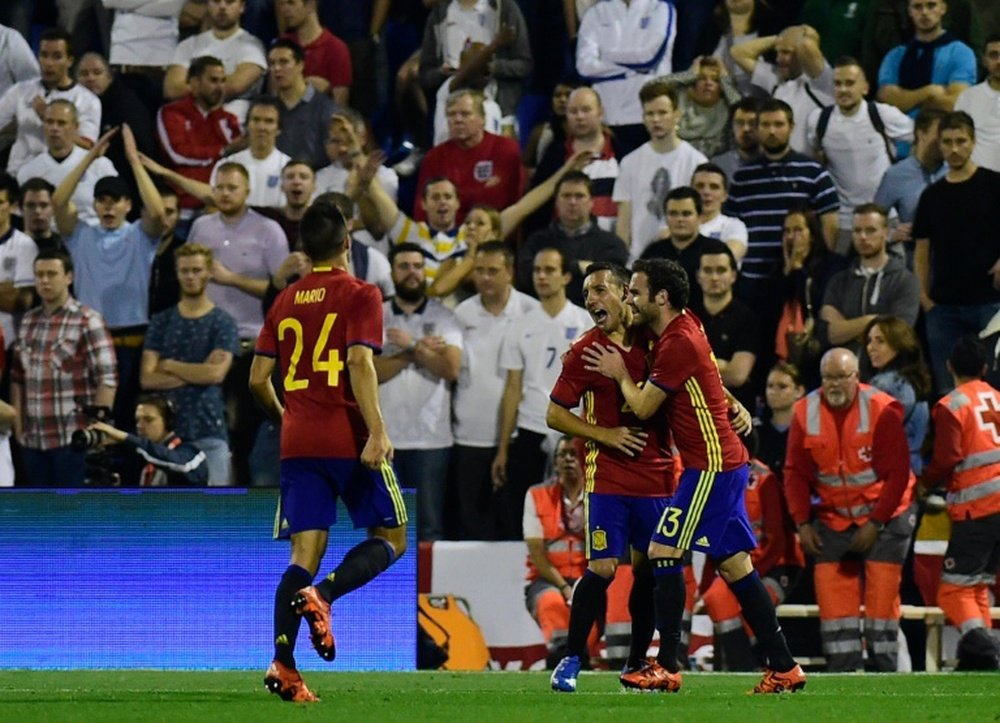 Spains midfielder Santi Cazorla (C) celebrates with Spains forward Juan Mata after scoring during the friendly football match Spain vs England at the Jose Rico Perez stadium in Alicante on November 13, 2015