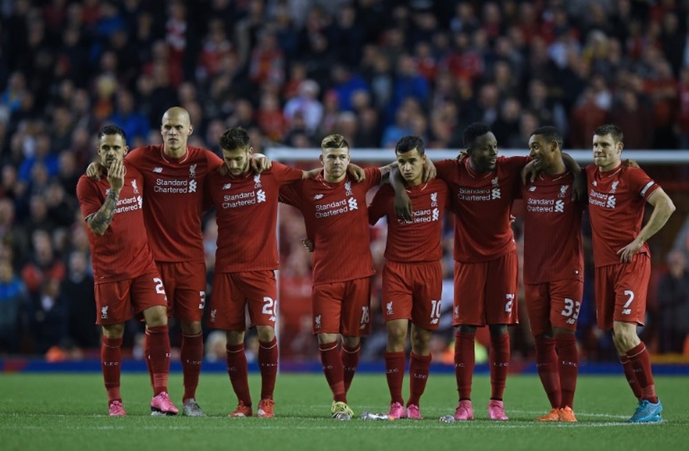Liverpool players huddle together during a penalty shootout against Carlisle United at Anfield on September 23, 2015