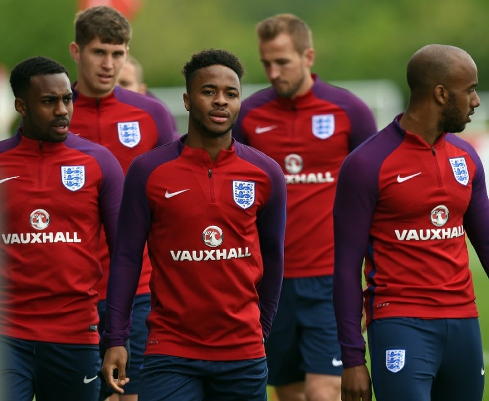 England's Danny Rose (L), John Stones (2nd L), Raheem Sterling (C), Harry Kane (2nd R) and Fabian Delph (R) take part in a training session at St George's Park