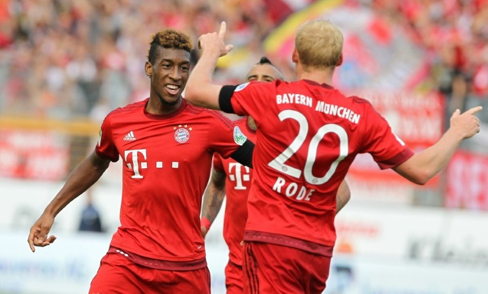 Bayern Munichs forward Kingsley Coman (L) celebrates scoring with his teammate Sebastian Rode during a German first division Bundesliga football match against Darmstadt in Darmstadt, southern Germany on September 19, 2015