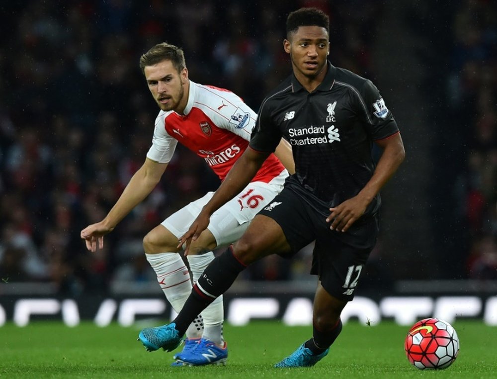 Liverpools Joe Gomez (R) runs past Arsenals Aaron Ramsey during their English Premier League match at the Emirates stadium in north London, on August 24, 2015