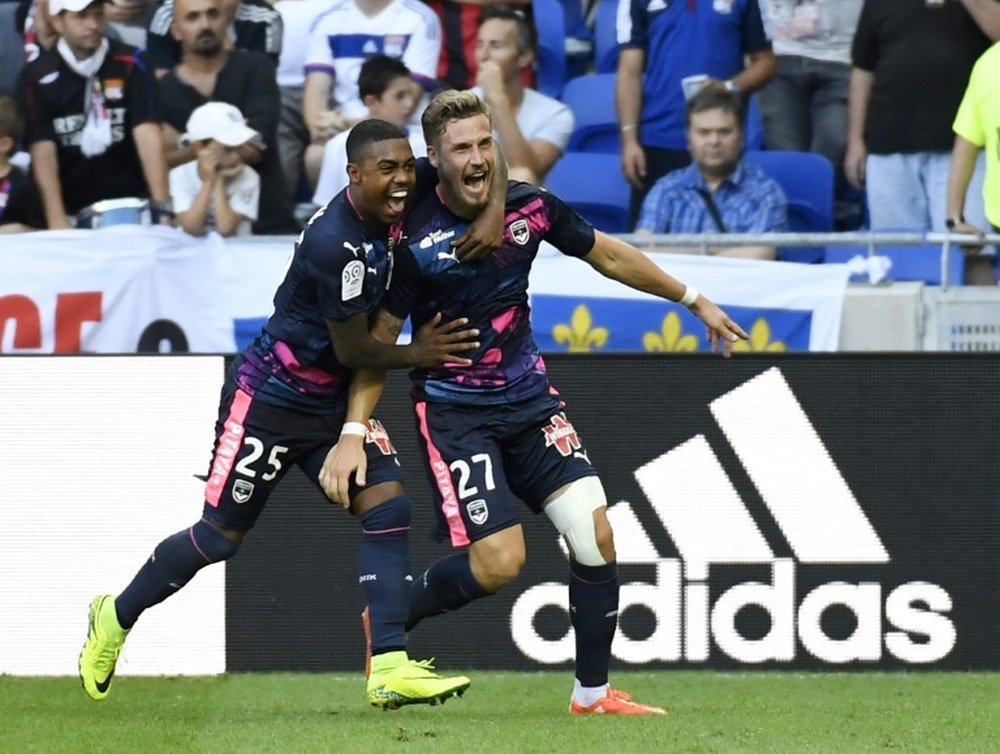 Bordeauxs French defender Gregory Sertic (R) is congratulated by teammate Malcom (L) after scoring a goal during the French L1 football match Olympique Lyonnais (OL) vs Girondins de Bordeaux on September 10, 2016