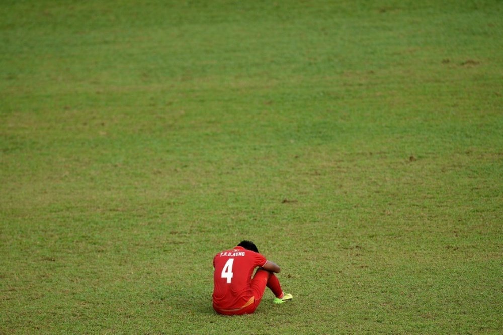 Myanmar's Thiha Htet Aung sits dejected after a defeat in the Southeast Asian Games. AFP