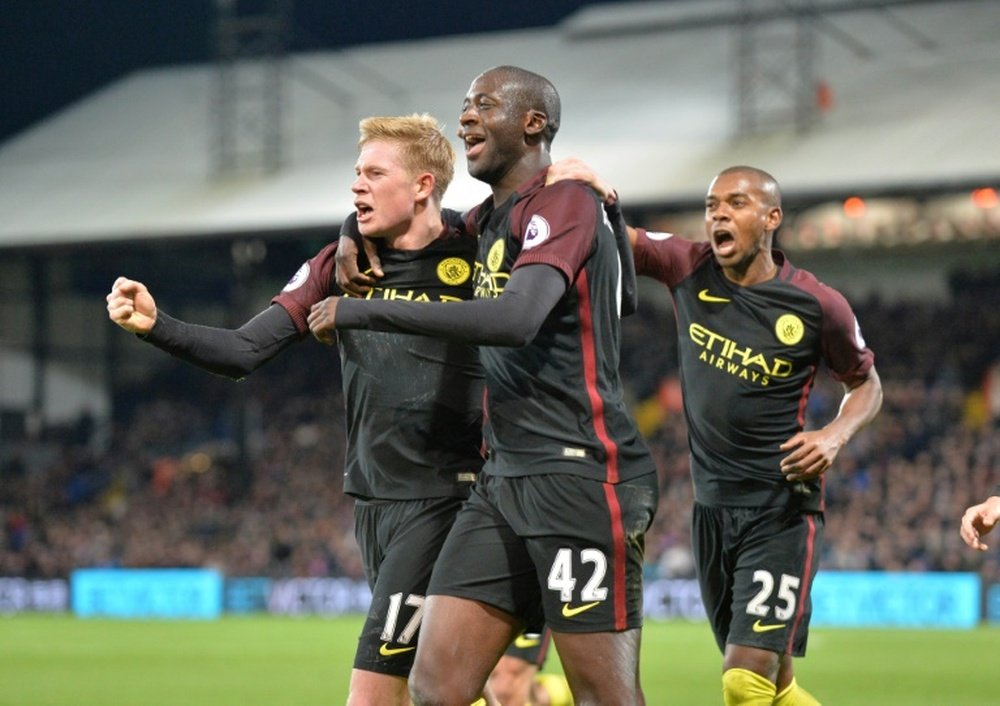 Manchester City's Yaya Toure (C) celebrates with Kevin De Bruyne (L) and Fernandinho (R) after scoring their second goal against Crystal Palace on November 19, 2016