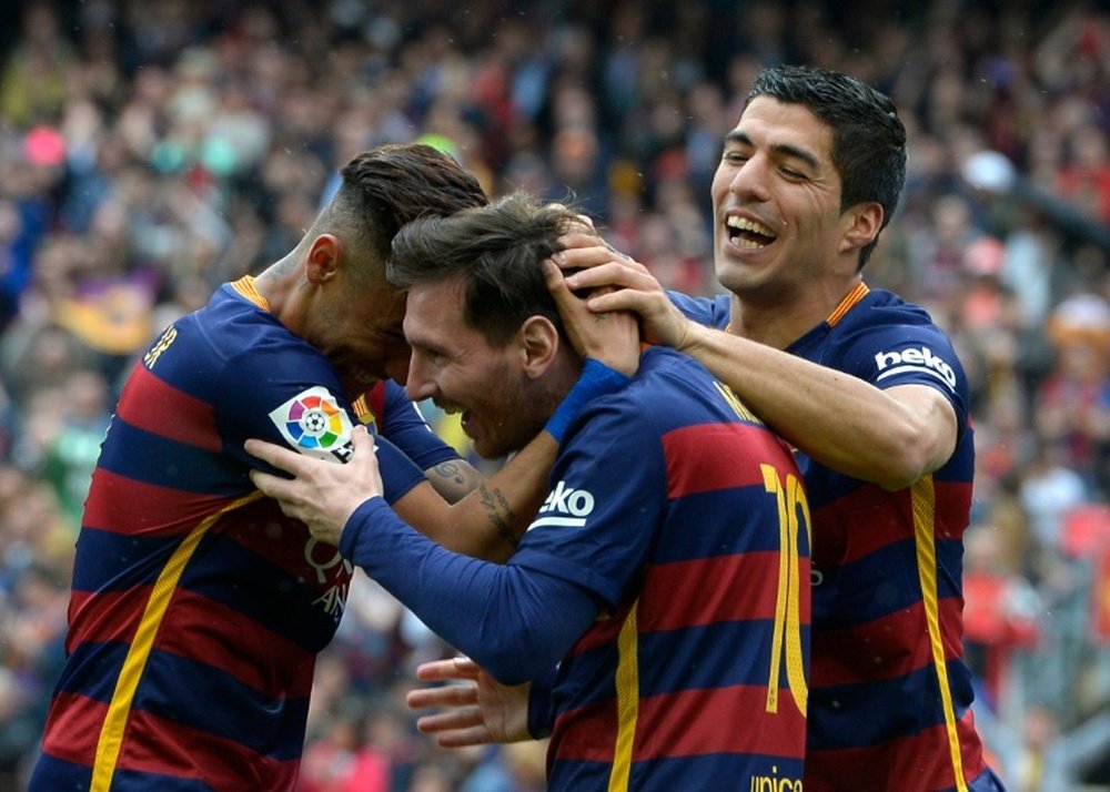 Barcelonas forward Lionel Messi (C) celebrates with forward Neymar and forward Luis Suarez (R) after scoring a goal during the Spanish league football match FC Barcelona vs RCD Espanyol at the Camp Nou stadium in Barcelona on May 8, 2016