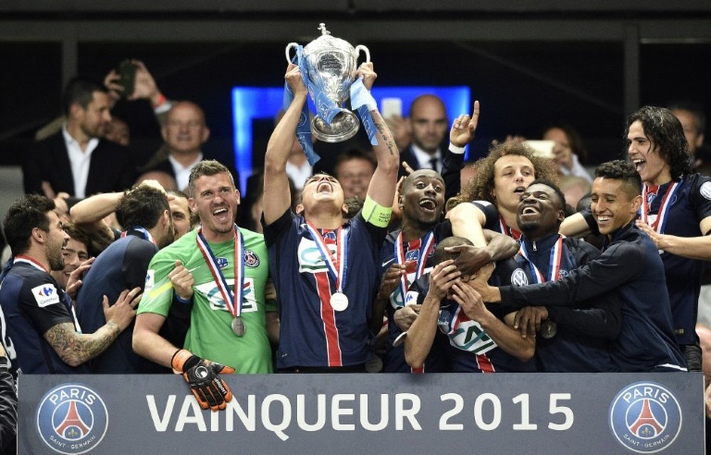 Paris Saint-Germains Thiago Silva holds up the trophy as players celebrate after winning the French Cup final on May 30, 2015