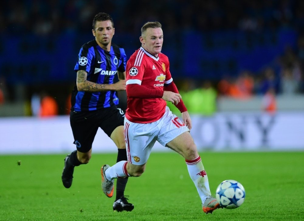 Manchester Uniteds Wayne Rooney controls the ball next to Club Brugges Claudemir during the UEFA Champions League playoff football match at Jan Breydel Stadium in Bruges, August 26, 2015