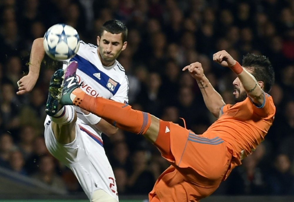 Valencias Spanish forward Alvaro Negredo (R) vies for the ball with Lyons French midfielder Maxime Gonalons during the Champions League group H football match on September 29, 2015 at the Gerland stadium in Lyon, France