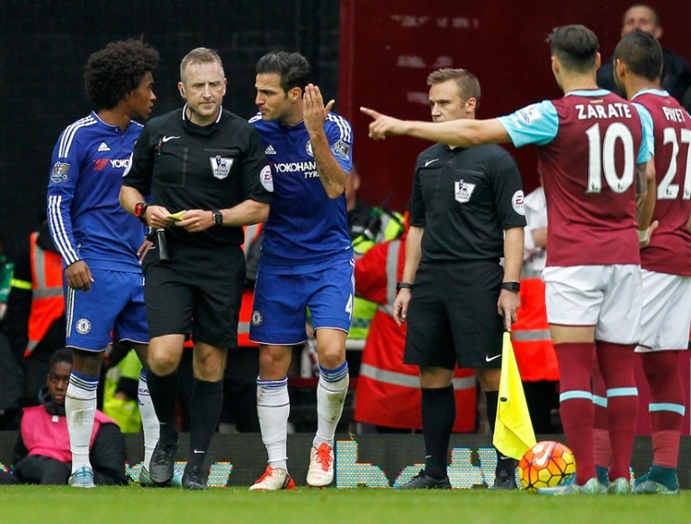 Chelseas Cesc Fabregas (3rd L) speaks with the referee following a challenge by Chelseas Nemanja Matic (not pictured) on West Ham Uniteds Diafra Sakho (not pictured) during a football match in Upton Park, London on October 24, 2015