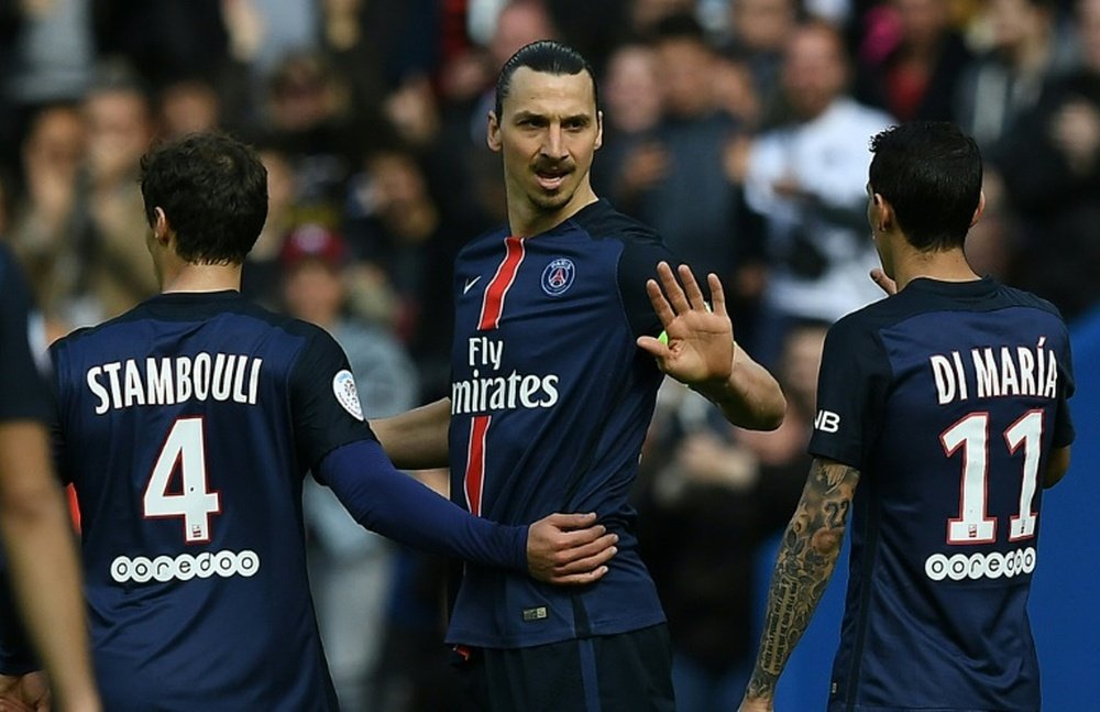 Paris Saint-Germains forward Zlatan Ibrahimovic (C) celebrates after scoring a goal during the French L1 match against Caen at the Parc des Princes stadium in Paris on April 16, 2016