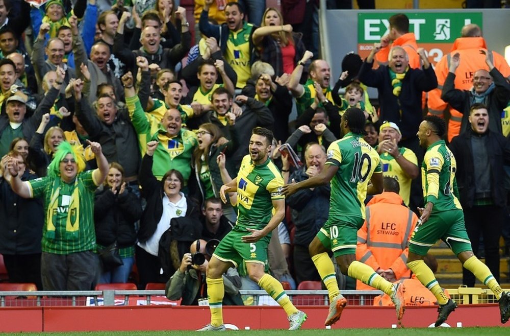 Norwich Citys defender Russell Martin (L) celebrates after scoring during an English Premier League football match against Liverpool at the Anfield stadium in Liverpool, north-west England on September 20, 2015