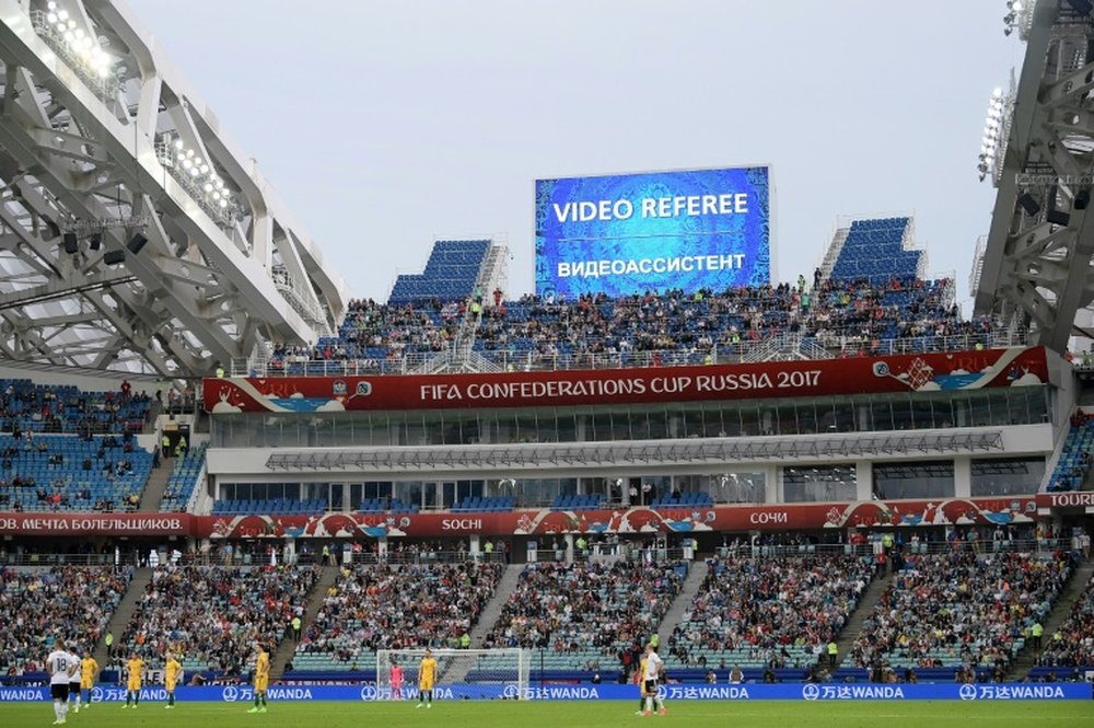 Players wait for a decision on a goal