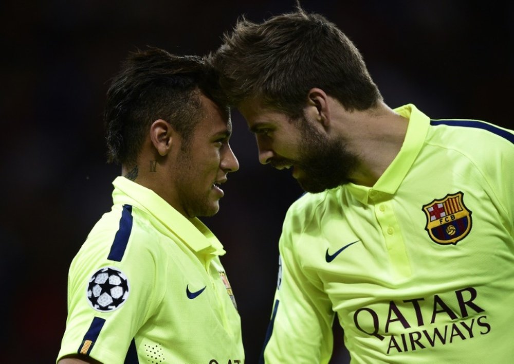 Barcelona's forward Neymar (L) celebrates with defender Gerard Pique after a goal in 2015