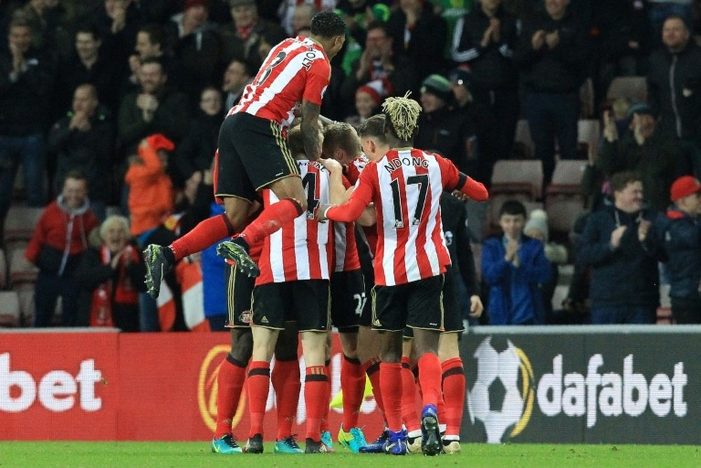 Sunderland players celebrate Robert Huth's own-goal. AFP