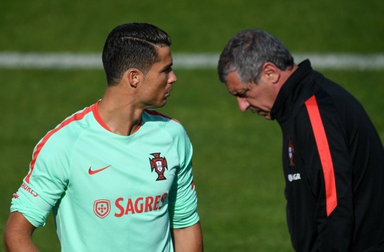 Portugal forward Cristiano Ronaldo talks with coach Fernando Santos at the team's Euro 2016 camp in Marcoussis, France, on June 15, 2016