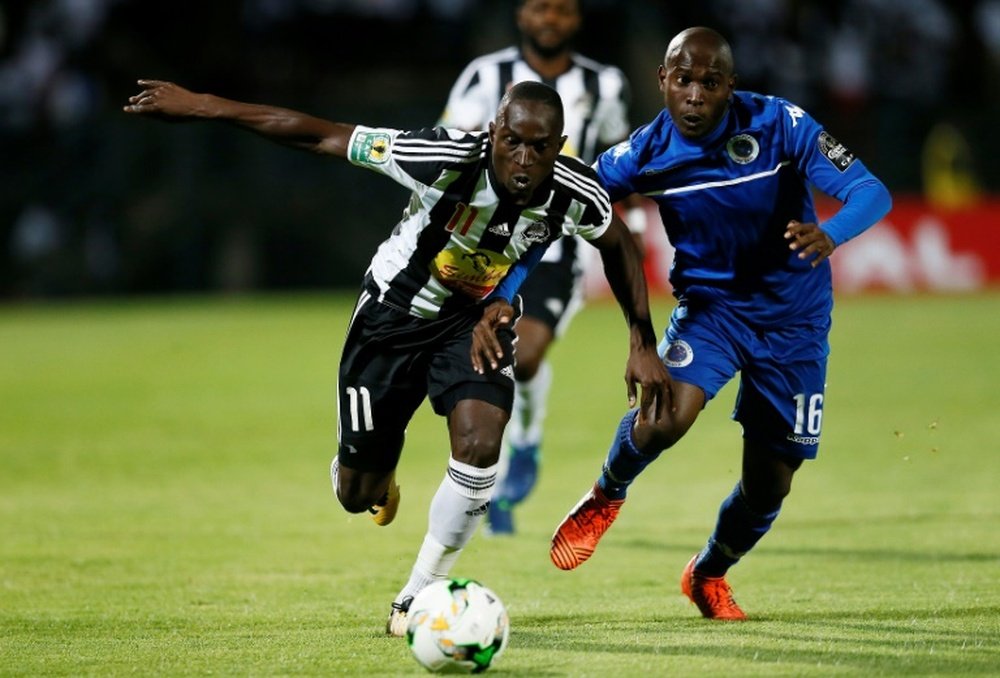 SuperSport United's Aubrey Bodiba and TP Mazembes' Adam Traore challenge for the ball. AFP