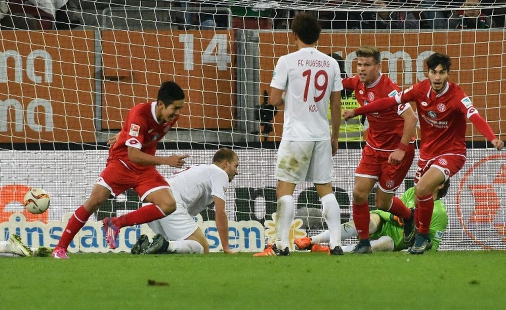Mainz Japanese striker Yoshinori Muto (L) celebrates scoring during the German first division Bundesliga football match FC Augsburg vs FSV Mainz in Augsburg, southern Germany, on October 31, 2015