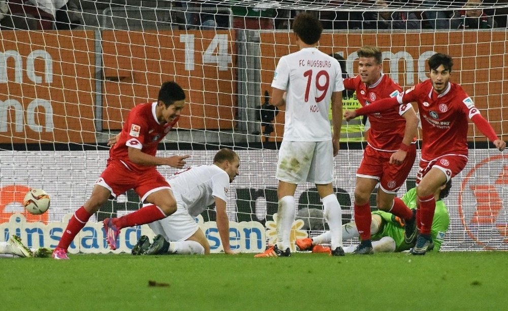 Mainz Japanese striker Yoshinori Muto (L) celebrates scoring during the German first division Bundesliga football match FC Augsburg vs FSV Mainz in Augsburg, southern Germany, on October 31, 2015