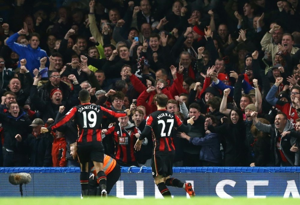 Bournemouth players celebrate with fans during the English Premier League football match between Chelsea and Bournemouth at Stamford Bridge in London on December 5, 2015