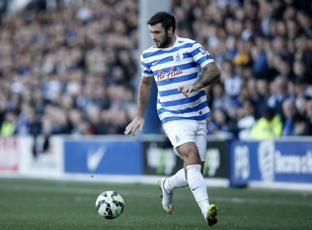 Queens Park Rangers English striker Charlie Austin runs with the ball during the English Premier League football match between Queens Park Rangers and Tottenham Hotspur at Loftus Road Stadium in London on March 7, 2015