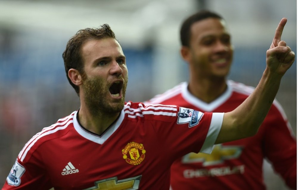 Manchester Uniteds Juan Mata (L) celebrates after scoring during the Premier League match against Swansea City at The Liberty Stadium in Swansea on August 30, 2015
