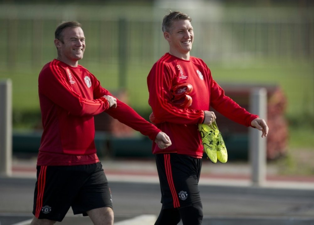 Manchester Uniteds Wayne Rooney (L) and Bastian Schweinsteiger arrive to take part in a team training session at their Carrington training complex in Manchester, England on September 29, 2015