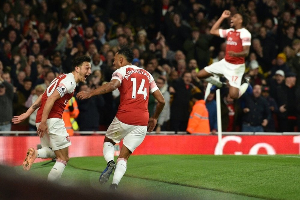 Pierre-Emerick Aubameyang celebrated with Mesut Ozil as Arsenal beat Leicester City. AFP