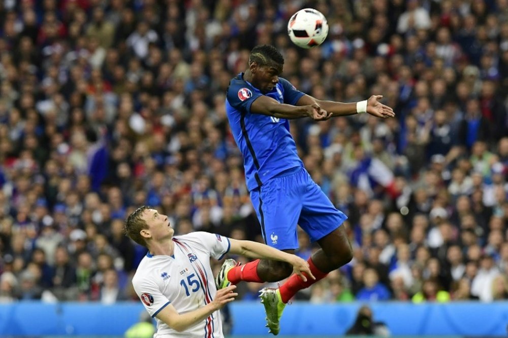 Icelands forward Jon Dadi Bodvarsson vies for the ball against Frances midfielder Paul Pogba during the Euro 2016 quarter-final football match between France and Iceland at the Stade de France in Saint-Denis, near Paris, on July 3, 2016