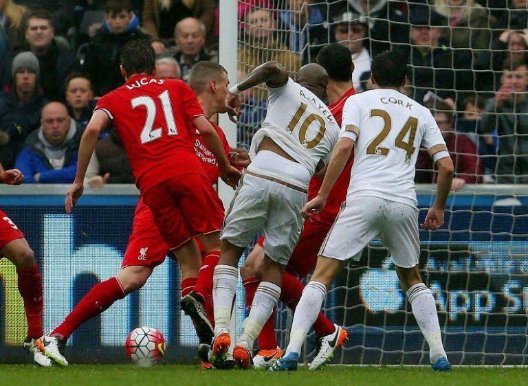 Swansea Citys Ghana striker Andre Ayew (C) scores his sides third goal against Liverpool. BeSoccer