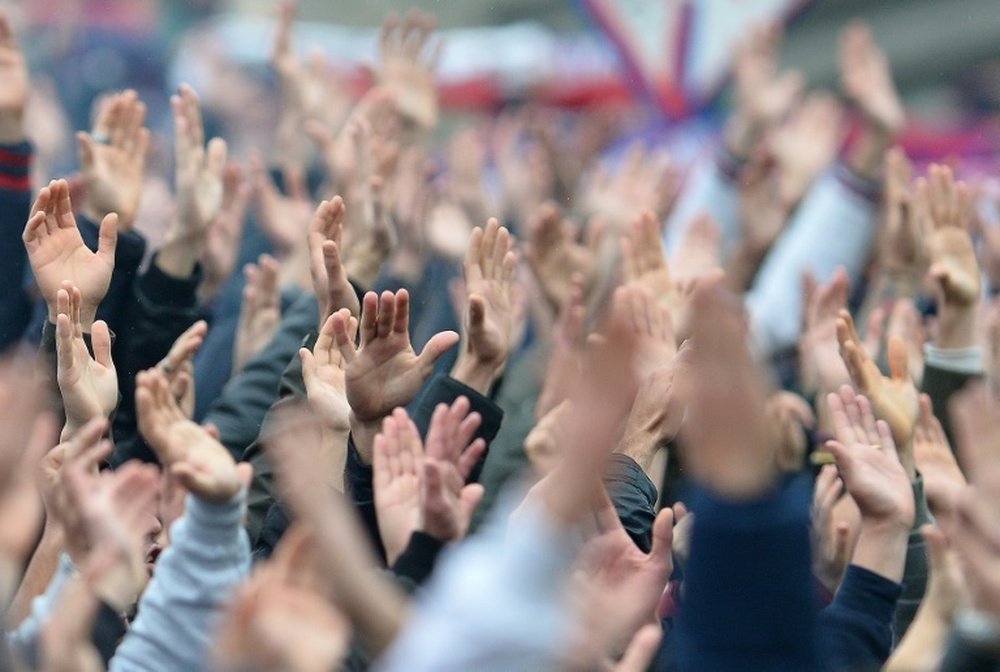 Cagliaris fans cheer their team during the Italian Serie A football match between Cagliari and Juventus on January 12, 2014