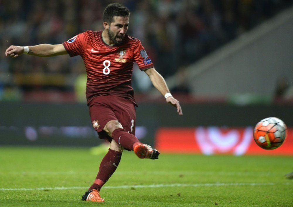 Portugals midfielder Joao Moutinho shoots to score a goal during the Euro 2016 qualifying football match Portugal vs Denmark at the Municipal stadium in Braga on October 8, 2015