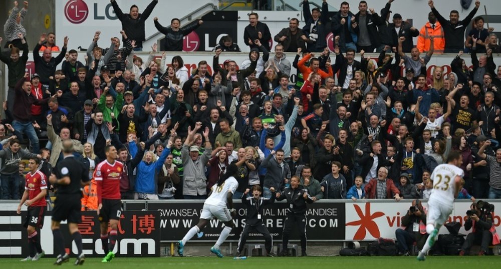 Swansea Citys striker Bafetimbi Gomis (C) celebrates after scoring during an English Premier League football match against Manchester United at The Liberty Stadium in Swansea, south Wales on August 30, 2015