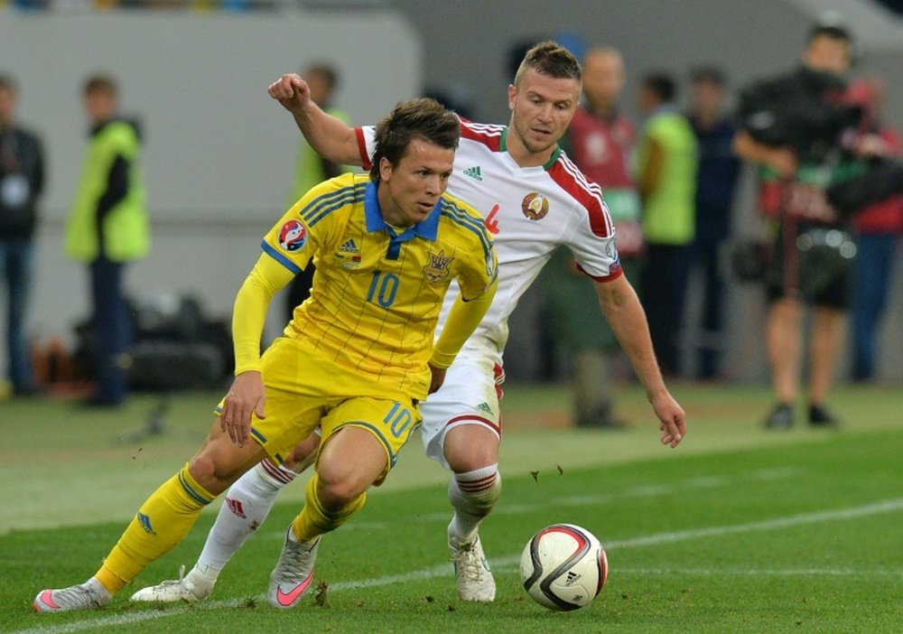 Ukraines Yevhen Konoplyanka (L) fights for the ball with Belarusian Igor Shitov during their Euro 2016 Group C match, at Arena Lviv stadium, in September 2015