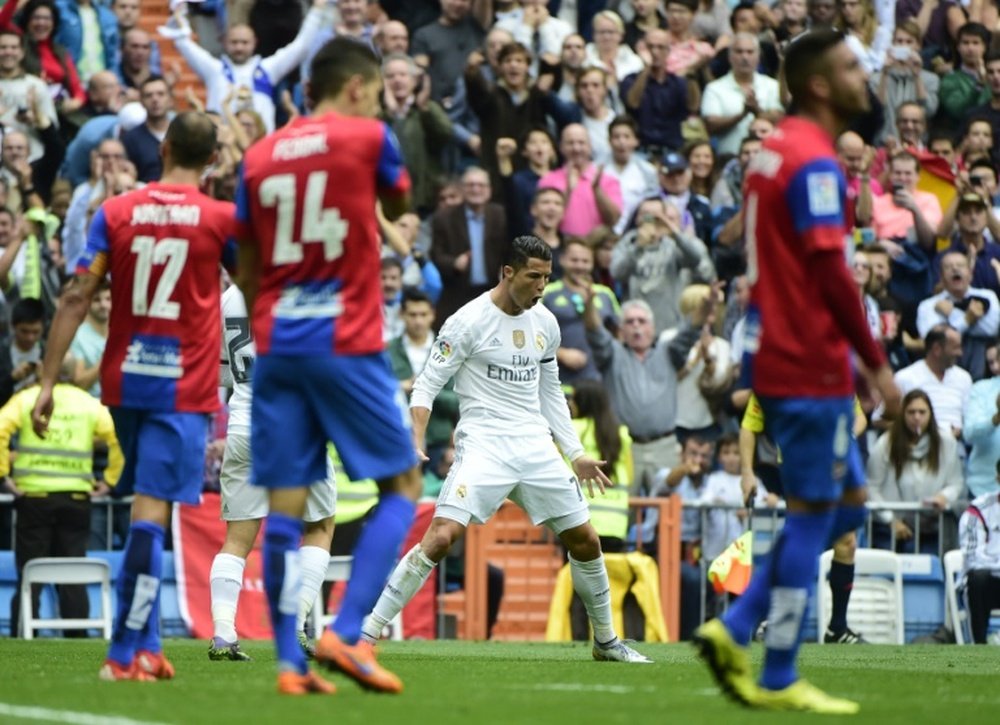 Real Madrids Portuguese forward Cristiano Ronaldo (C) celebrates a goal during the Spanish league football match Real Madrid CF vs Levante UD at the Santiago Bernabeu stadium in Madrid on October 17, 2015
